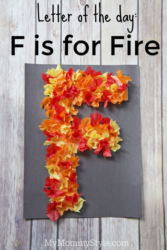 the letter f is for fire made out of flowers on a piece of gray paper