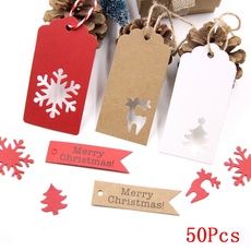 christmas tags with bows and snowflakes on them are surrounded by other holiday decorations