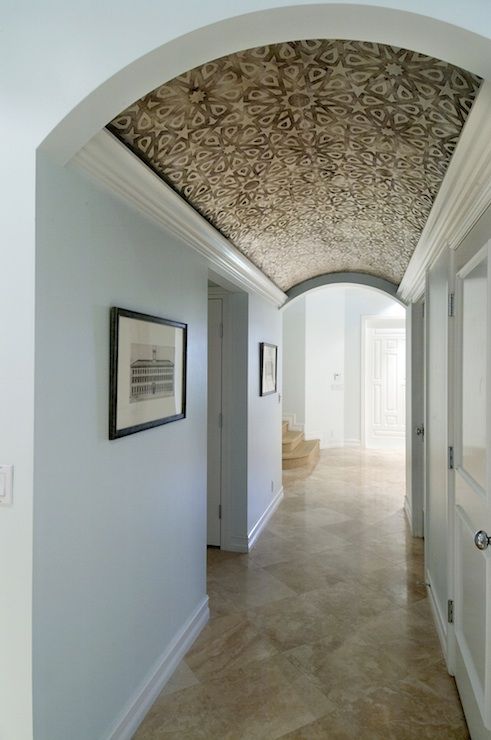 an archway leading into a hallway with white walls