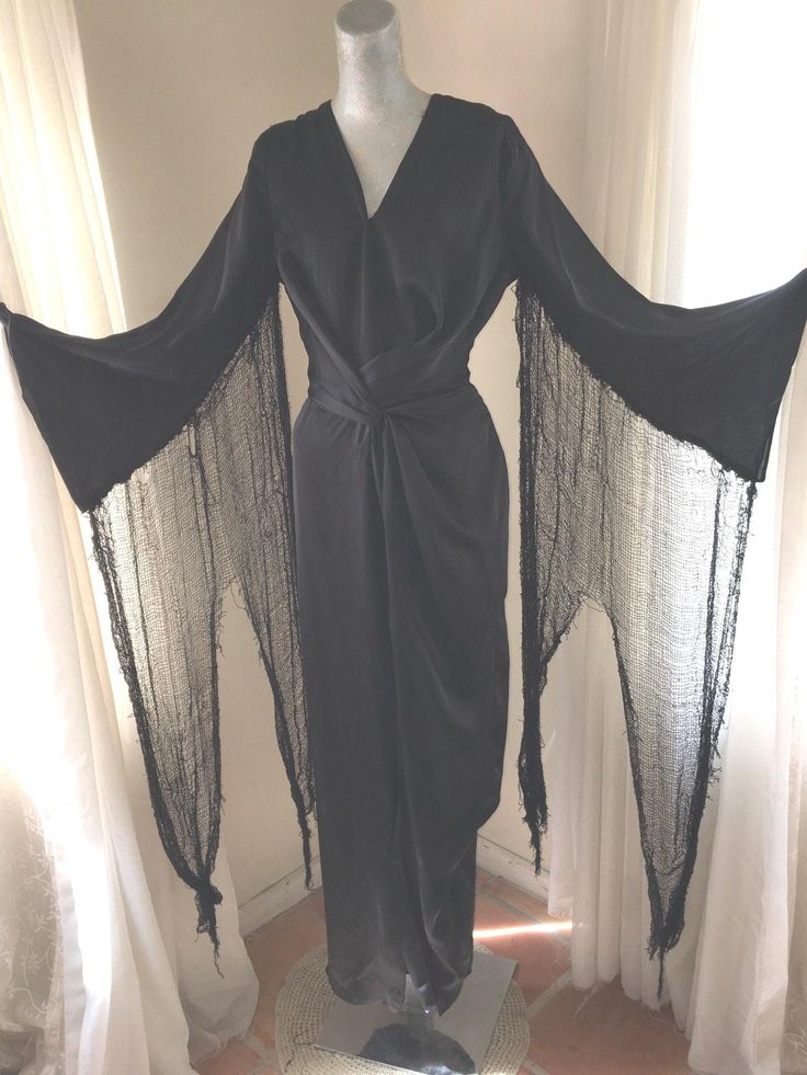 1930s style Morticia Addams dress, original design.  Very slinky, no stretch to fabric.  Size small/ medium with shredded sleeves that peak almost to the ground, shredding goes all the way from under your arm to wrist.  V neck bodice, gathered/wrapped waistline in front, deep front slit to hem.  Hidden left side zipper.  Dress is very fitted and slinky, quite glamorous.  Morticia Addams character was created in the 1930s.  I think Morticia herself would approve.  Excellent condition.  Shown on a Morticia Addams Dress, Addams Dress, 1930s Style, Morticia Addams, Zipper Dress, 1930s Fashion, Layer Dress, Other Outfits, Women's Costumes