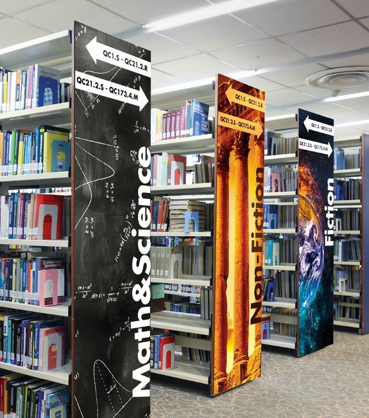 the bookshelves are full of books and signs