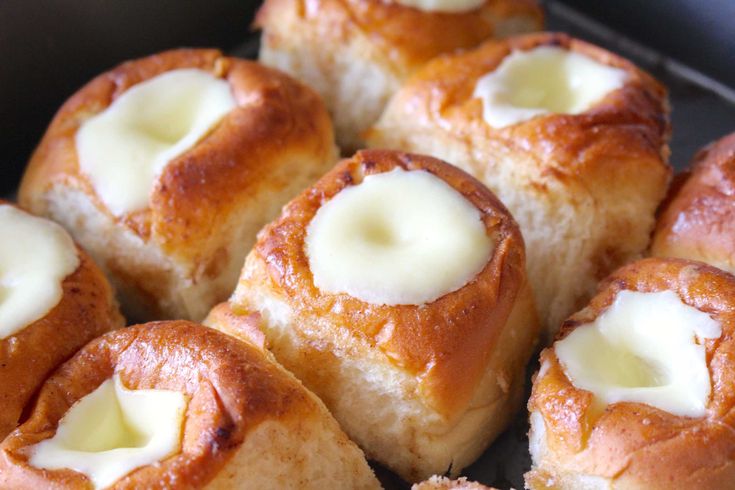 several rolls with butter on them sitting in a pan