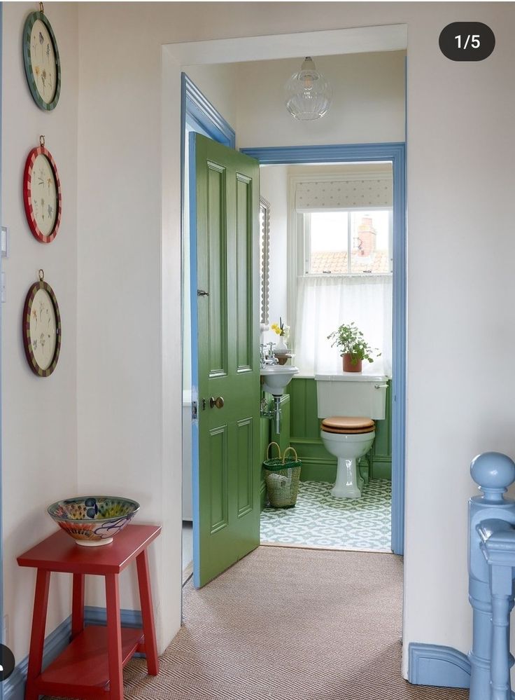 an open door leading to a bathroom with green doors