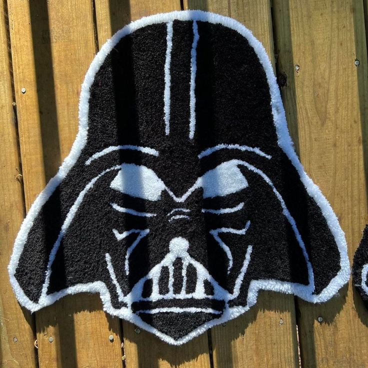 a darth vader towel is hanging on a wooden fence