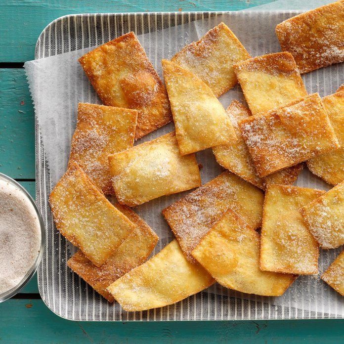 some food that is on a tray and next to a cup