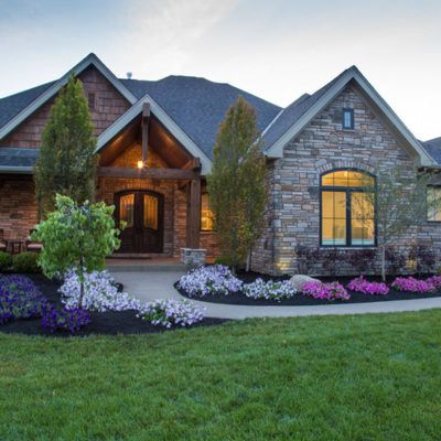 a large house with landscaping in front of it