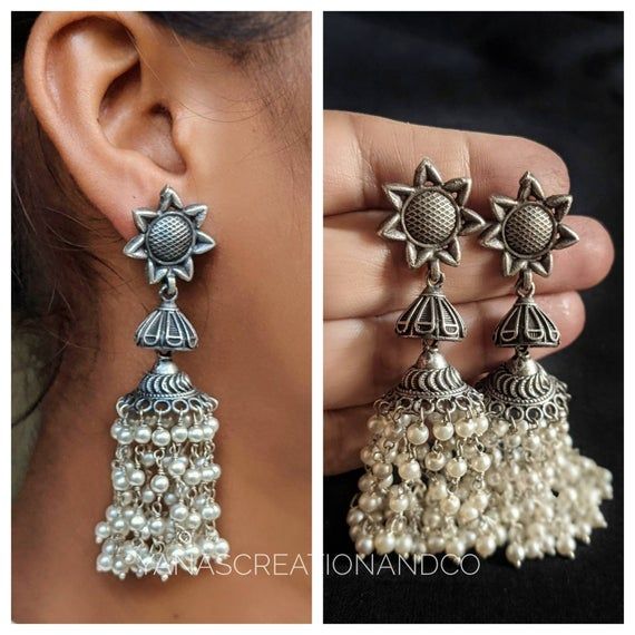 Add charm and charisma to your beautiful personality with these exquisitely designed and handcrafted high quality suryankanti earrings lined with fine lustrous pearls.Pair them up with any formal or semi formal attire and gather compliments wherever you go. Suitable for both casual and dressy occasions.Colour: Antique Length 2.8 inches Each earring weighs 12 gms (lightweight)*****************************************Note: All in stock items will be shipped from New Delhi, India within 2-3 busines Traditional Metal Earrings With Pearl Drop, Bohemian Silver Bridal Earrings With Latkans, Bohemian Bridal Earrings With Latkans In Silver, Bohemian Bridal Silver Earrings With Latkans, Traditional Round Sterling Silver Pearl Earrings, Traditional Silver Pearl Earrings, Traditional Pearl Drop Earrings In Sterling Silver, Elegant Silver Jhumkas For Festival, Traditional Silver Sterling Pearl Earrings