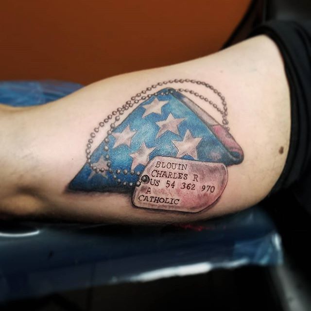 a person with a tattoo on their arm that has a hat and stars on it