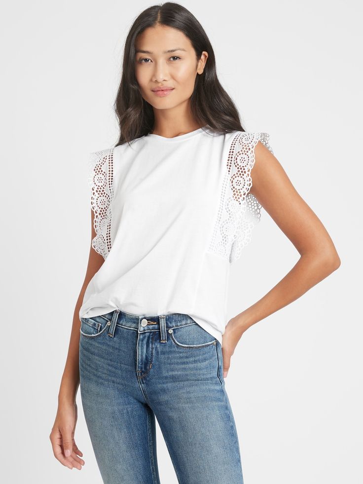 BACK IN STOCK: You loved this style so much we're bringing it back! Easy on the eyes.  This cute tank has rows of ruffled lace at the sleeves for a luxe, textured look.  Crew neck.  Sleeveless.  Straight hem.  Semi-fitted.  Hip length - designed for mid-rise and high-rise styles.  Body length (size S): Regular 23. 75" Model: Size XS, 5'10" (178cm). Feminine Cotton Tops With Lace Sleeves, Chic Cotton Tops With Lace Sleeves, Chic Sleeveless Crochet Top With Ruffles, Chic Crew Neck Top With Lace Sleeves, Summer Cotton Lace Top With Lace Sleeves, Sleeveless Cotton Lace Top With Ruffles, Feminine Tops With Lace Trim And Ruffle Sleeves, Feminine Tops With Lace Trim And Flutter Sleeves, Chic Cotton Tank Top With Lace Trim