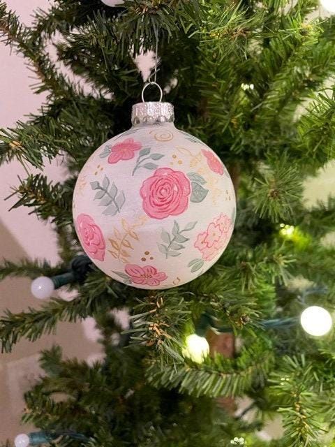 an ornament hanging from the top of a christmas tree