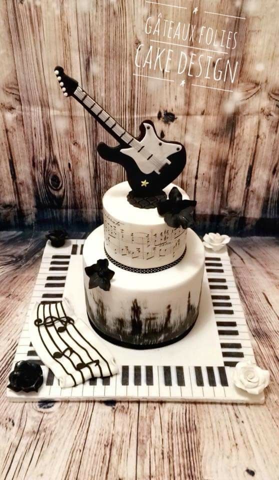 there is a cake with an electric guitar decoration on the top and bottom tiers