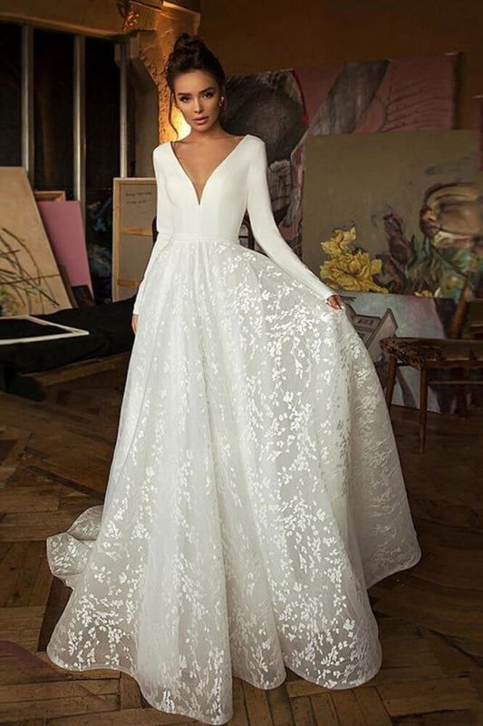 a woman in a white wedding dress posing for the camera