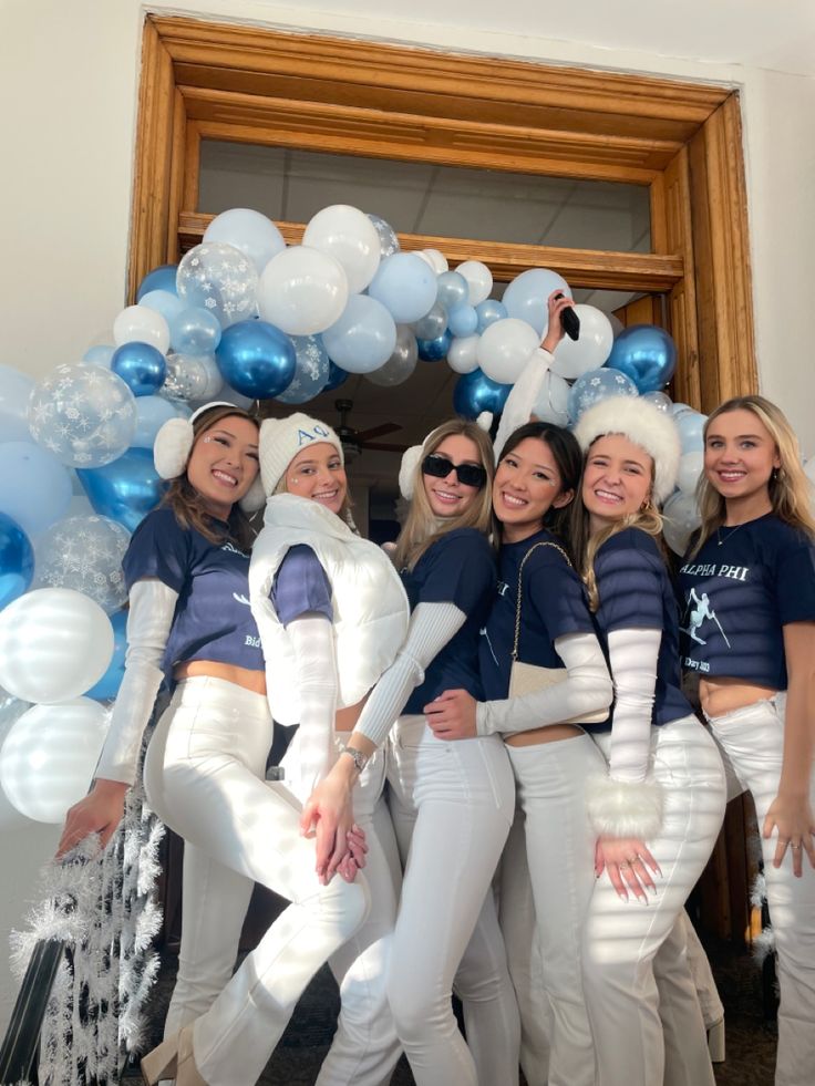 the girls are all dressed up in white and blue