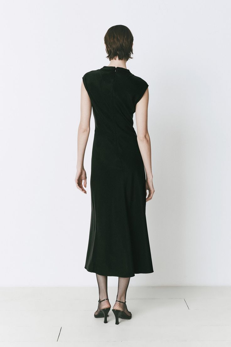 Black midi dress with a mock neck and silky finish. True-to-size fit, blending modern style and effortless fall sophistication. Formal Fall High Neck Midi Dress, Formal High-neck Midi Dress For Fall, Formal High Neck Midi Dress For Fall, Elegant Solid Color Turtleneck Dress, Elegant Solid Turtleneck Dress, Elegant Turtleneck Dress, Elegant High Neck Midi Dress For Fall, Spring Evening Turtleneck Midi Dress, Chic Formal Turtleneck Dresses