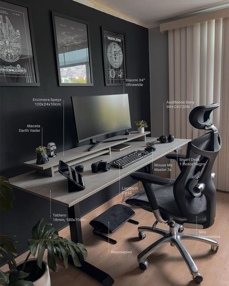 an office with black walls and wooden flooring, including a computer desk in the center