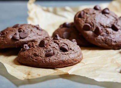 chocolate chip cookies are sitting on wax paper