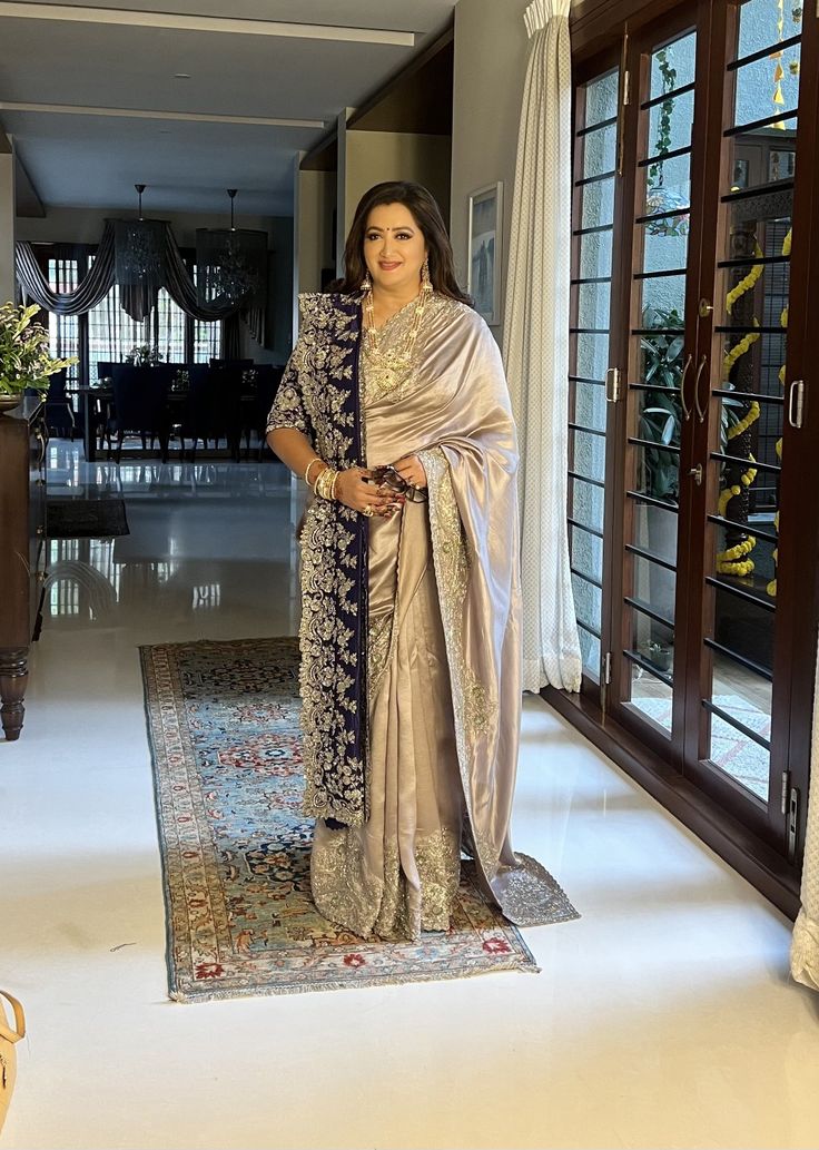 a woman in a sari standing on a rug