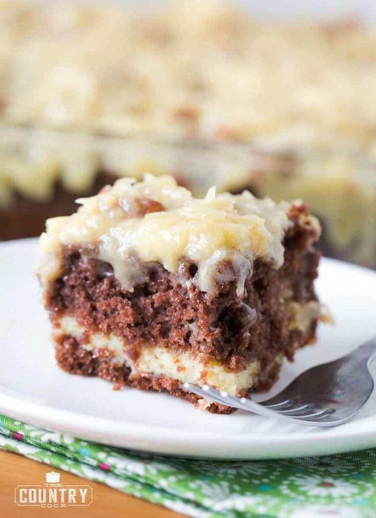 a piece of german chocolate cheesecake cake on a white plate with a fork next to it