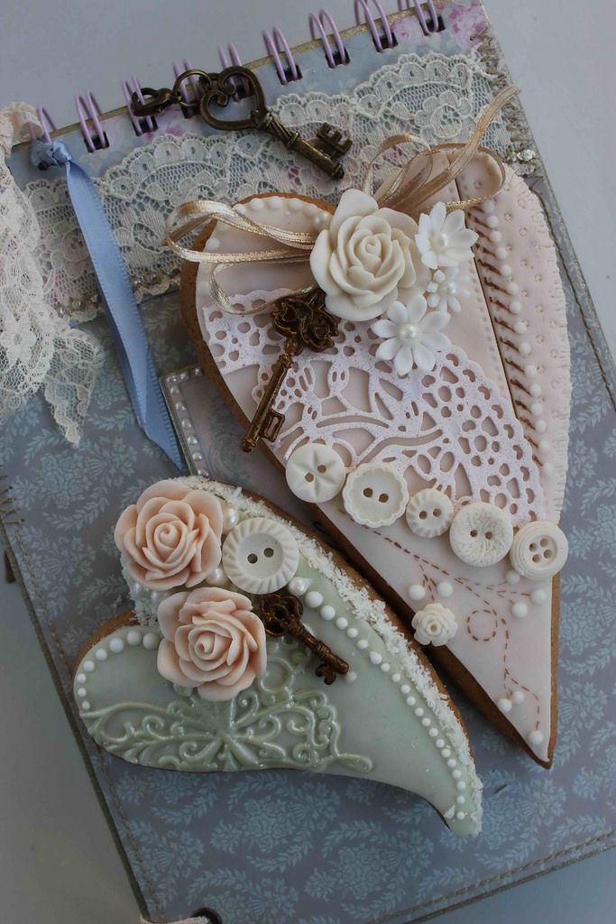 two pieces of paper with lace and flowers on them are sitting next to each other