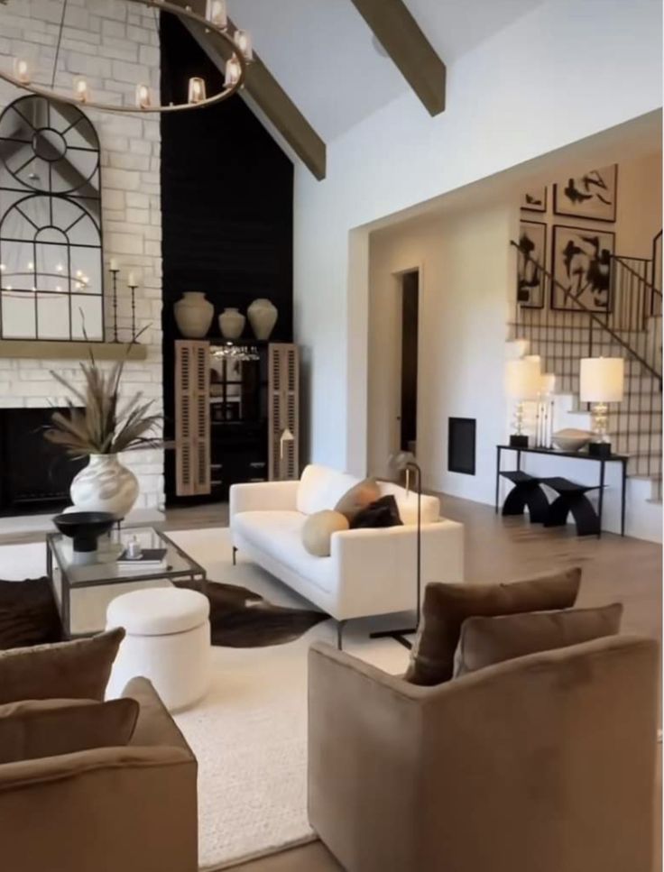 a living room with couches, chairs and a fireplace in it's center