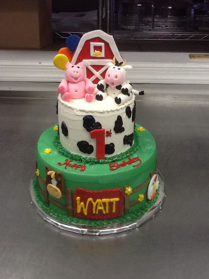 a three tiered cake decorated with farm animals