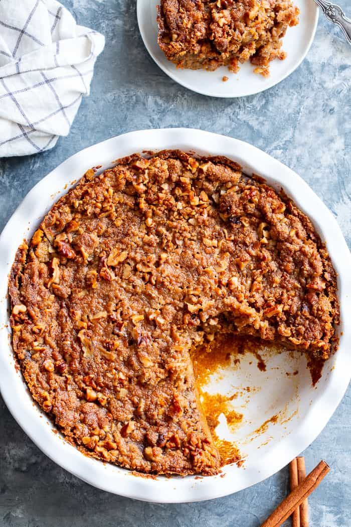 a pie with one slice missing from it on a plate next to another pie dish