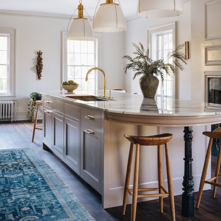 a kitchen island with two stools next to it