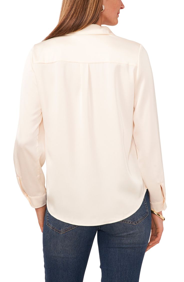 Chest-flap pockets front this polished blouse designed with an easy-moving back pleat and a curved shirttail hem. Spread collar Long sleeves 100% polyester Hand wash, line dry Imported Elegant Tops With Pockets And Shirttail Hem, Business Casual Tops With Pockets And Shirttail Hem, Chic Business Casual Tops With Pockets, Elegant Blouse With Pockets And Shirttail Hem, Solid Color Shirttail Hem Top For Workwear, Versatile Solid Color Blouse With Shirttail Hem, Versatile Solid Blouse With Shirttail Hem, Solid Blouse With Pockets And Shirttail Hem, Workwear Blouse With Shirttail Hem