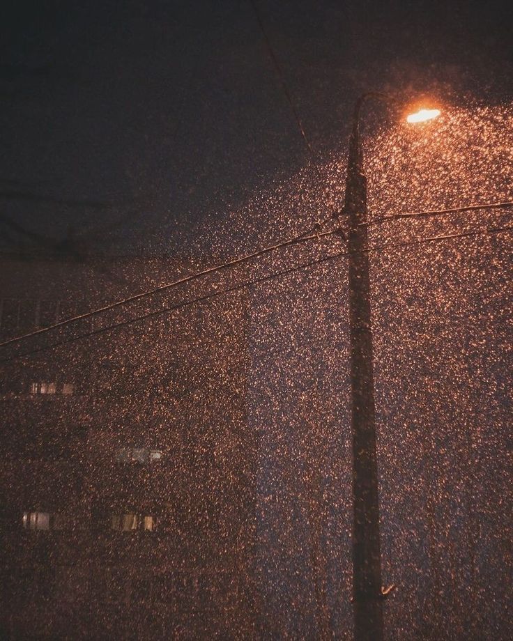 a street light in the rain at night