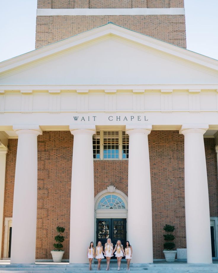 three girls standing in front of a building with columns and the words wait chapel on it