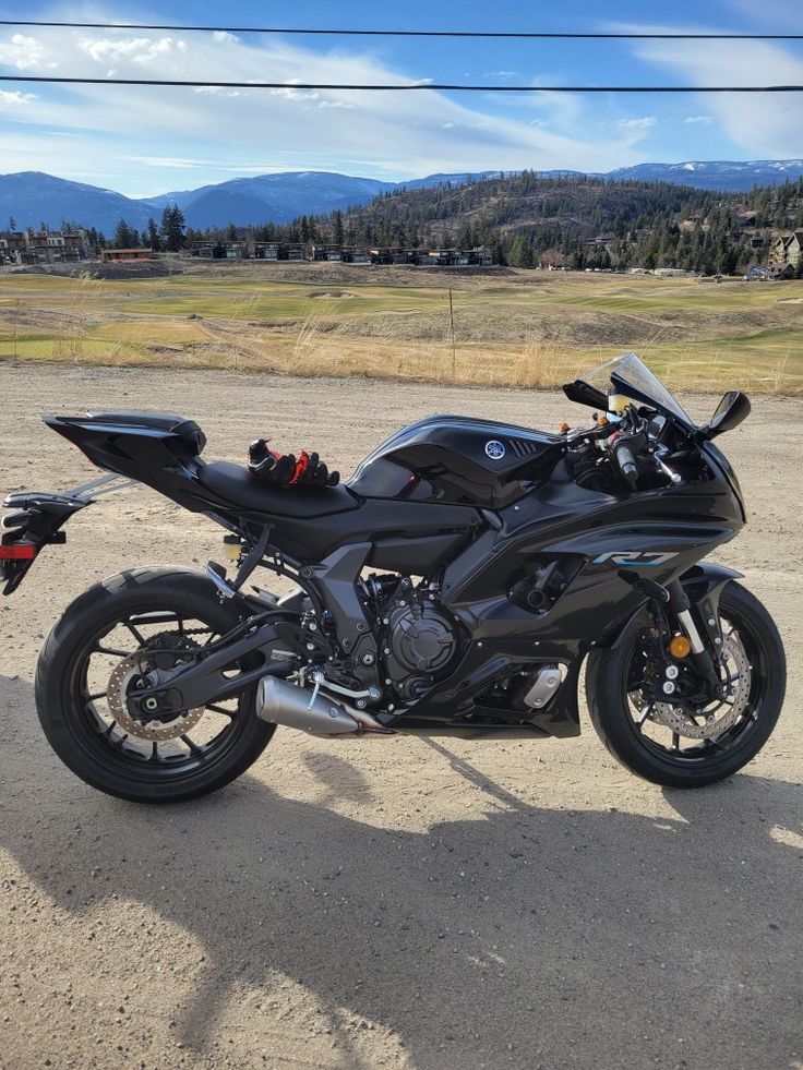 a black motorcycle parked on the side of a road