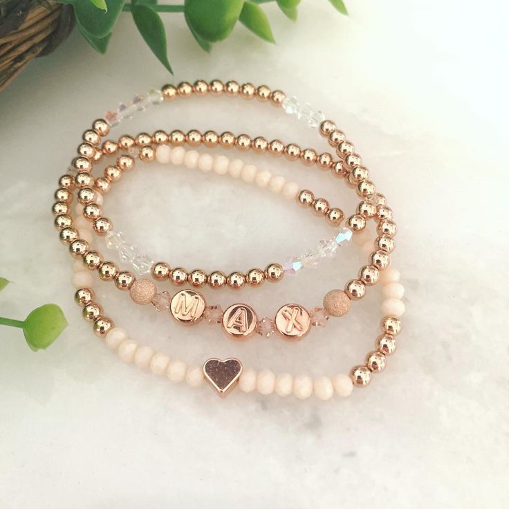 "BLUSH STACK 🌸 3 BRACELETS  * high quality metal spacer beads available in 14k gold fill, or 14k rose gold fill  * rose crystals & stardust accents  * peach faceted oval beads & small heart shape charm  * iridescent crystals 🌷Rose Gold option comes with 14k rose gold filled round beads, rose gold letters, rose gold stardust beads on sides of letter beads & rose gold colored heart 🌻Gold option comes with 14k gold filled round beads, white with gold letters, gold stardust beads on sides of lett Rose Gold 14k Gold-filled Bracelets As Gift, Dainty Beaded Name Bracelet, Rose Gold 14k Gold-filled Bracelet Gift, Customizable Rose Gold Jewelry For Everyday, Customizable Everyday Rose Gold Jewelry, Elegant Personalized Rose Gold Beaded Bracelets, Elegant Personalized Rose Gold Beaded Bracelet, Everyday Spiritual Jewelry With Custom Name, Rose Gold Beaded Bracelets As Gift