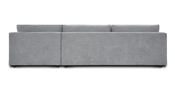 a gray couch sitting on top of a white floor