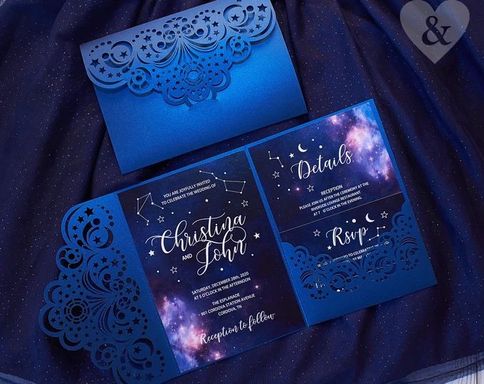 the wedding stationery is blue and has laser cut designs