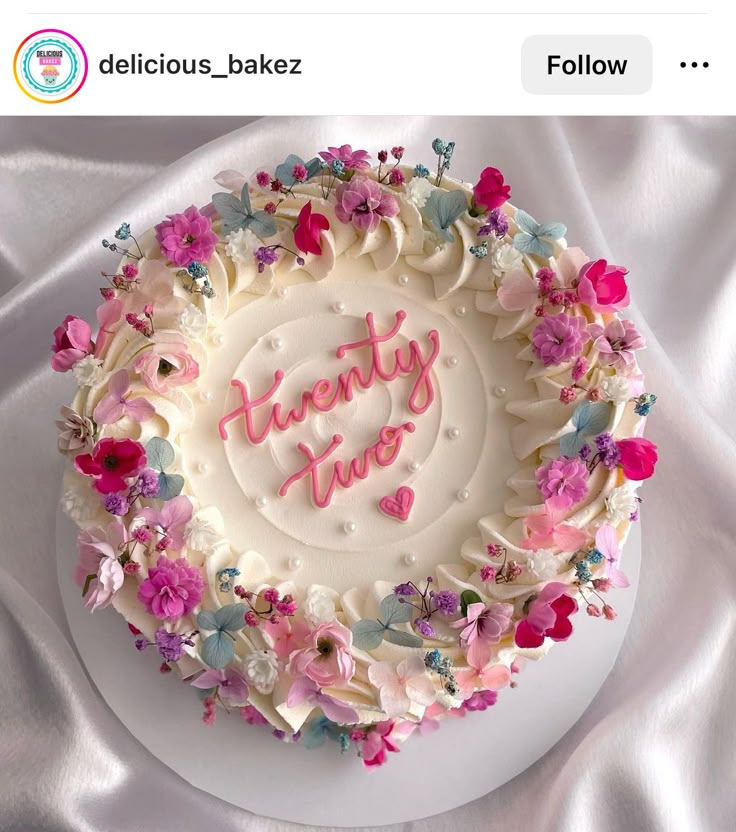 a birthday cake decorated with flowers and the words happy new year written in frosting