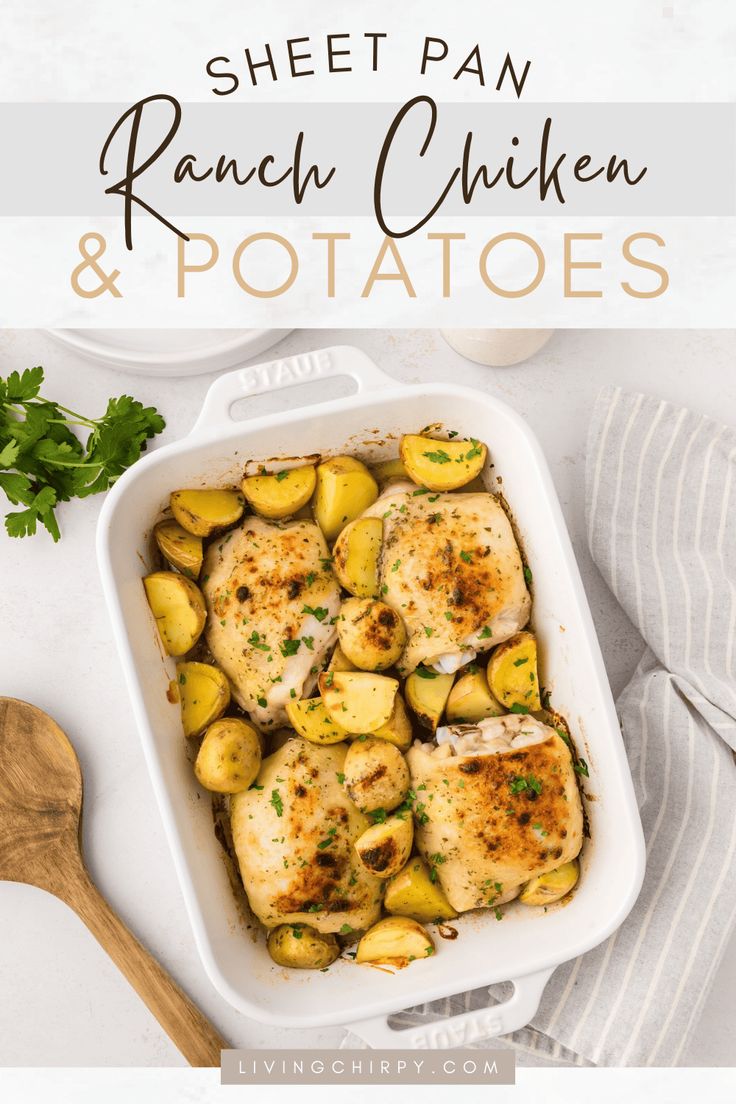 sheet pan ranch chicken and potatoes in a white casserole dish with parsley on the side