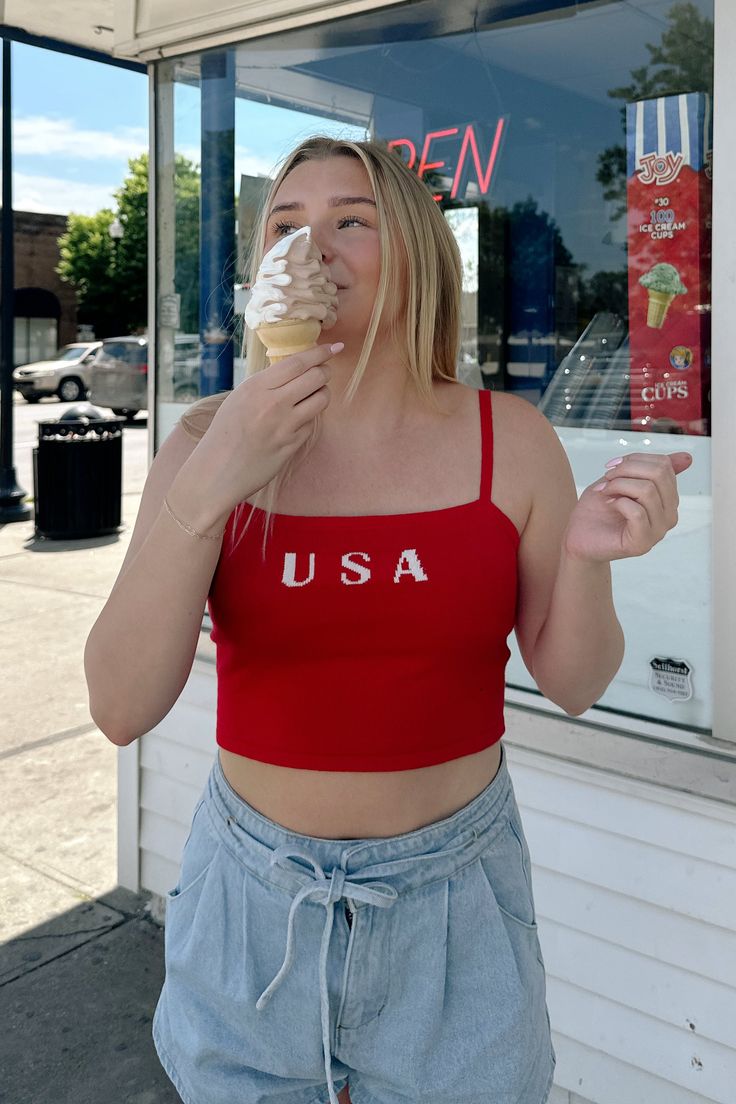 Celebrate the Fourth of July with our new USA Crop Top! This new arrival features a soft knit material, a square neckline, cami adjustable straps, and a cropped length. Pair this one with your favorite denim! Available in navy and red. cotton nylon hand wash with cold water lay flat to dry iron if needed Models are wearing a size small Casual Crop Top With Tank Straps, Red Trendy Camisole Crop Top, Trendy Red Camisole Crop Top, Trendy Red Crop Top With Built-in Bra, Red Casual Camisole Crop Top, Casual Red Camisole Crop Top, Red Camisole Crop Top Casual Style, Casual Stretch Cropped Camisole, Casual Red Tank Strap Tops