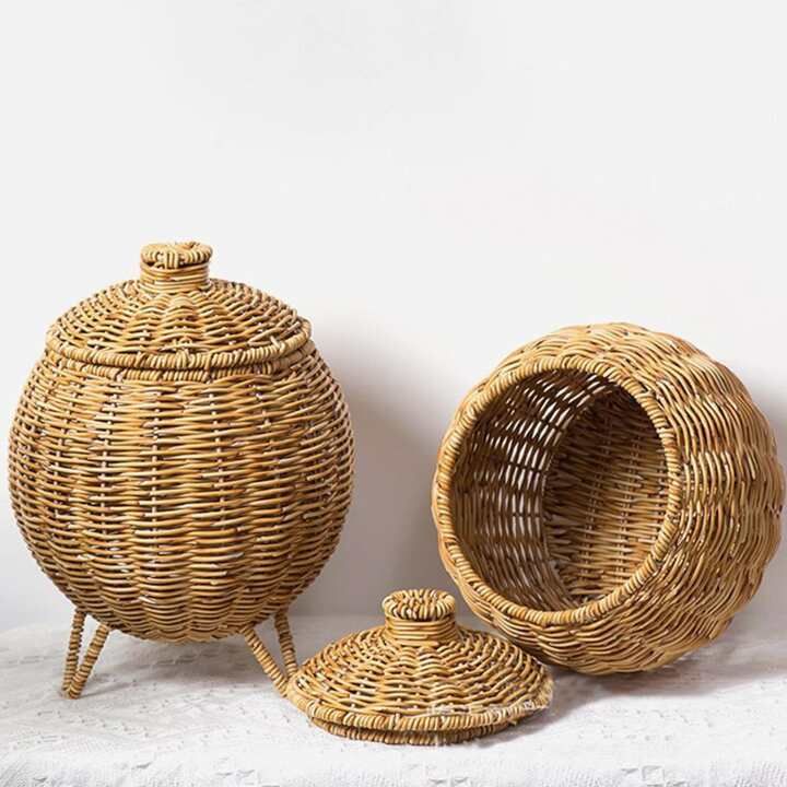 two wicker baskets sitting next to each other on a white cloth covered tablecloth