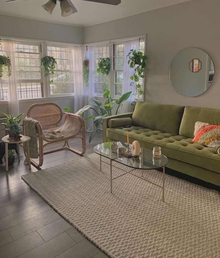 a living room filled with furniture and lots of plants on top of it's walls