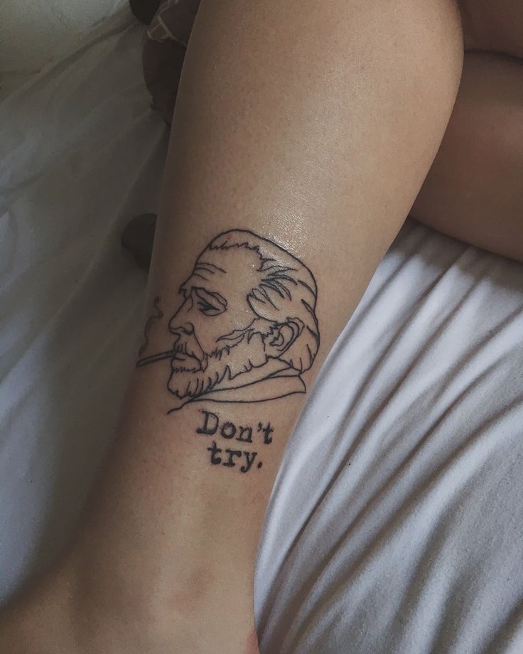 a woman with a tattoo on her leg that says don't try