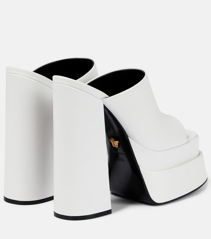 Leather platform mules in white - Versace | Mytheresa Luxury White Mules With Sculpted Heel, Modern White Mules With Sculpted Heel, Designer White Open Heel Mules, White Square Toe Mules With Branded Heel, Luxury White Square Toe Sandals, Luxury Leather Platform Slides, Luxury White Mules For Evening, White Luxury Formal Mules, Luxury White Evening Mules