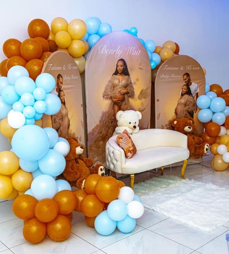 a teddy bear sitting on top of a couch next to balloons and signs with pictures