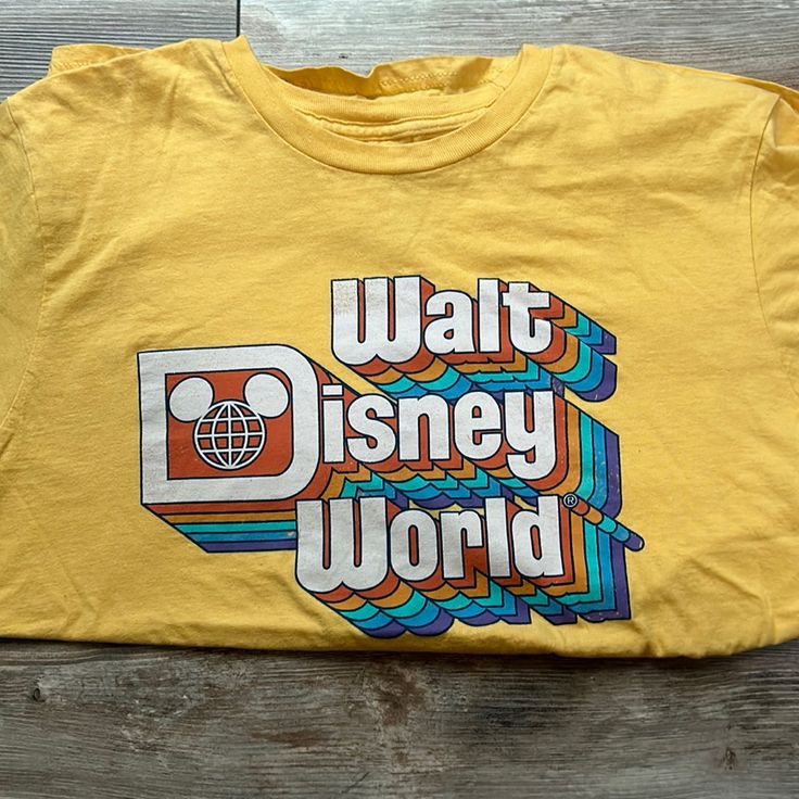 Yellow Short Sleeved Souvenir T-Shirt From Disney World In Orlando Washed, But Never Worn Size Medium The Colors Just Aren’t My Style Casual Multicolor T-shirt For Disney Trips, Themed Letter Print Shirt For Disney Trips, Multicolor Cotton T-shirt For Disney Trips, Themed Graphic Print Shirt For Disney Trips, Disney Cotton Shirt, Disney-themed Cotton Shirt, Themed Multicolor Tops With Letter Print, Multicolor Themed Tops With Letter Print, Fun Letter Print T-shirt For Disney Trips