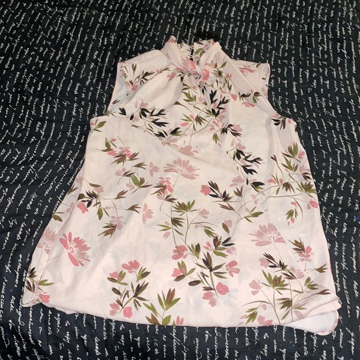 Light Pink Flowers With Stems On The Blouse The Front Opens To The Waist And Has 1 Small Button To Keep It Closed Very Flowey And Loose 2 Buttons To Close The Back Where The Collar Is Never Worn Fitted Sleeveless Blouse With Floral Print, Feminine Sleeveless Floral Print Blouse, Casual Tank Blouse With Floral Print, Pink Floral Print Sleeveless Blouse, Elegant Floral Print Sleeveless Blouse, Elegant Sleeveless Blouse With Floral Print, Feminine Sleeveless Blouse With Floral Print, Floral Print Sleeveless Blouse For Spring, Sleeveless Floral Print Blouse For Work