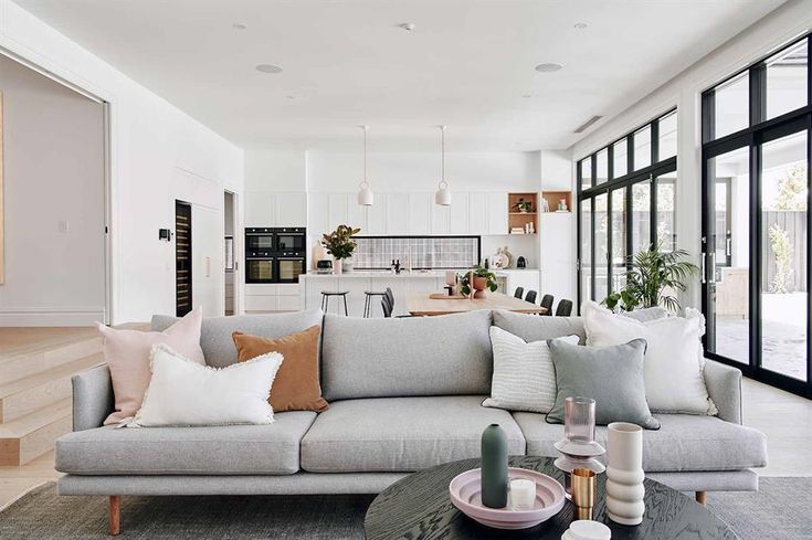 a living room filled with furniture and lots of windows