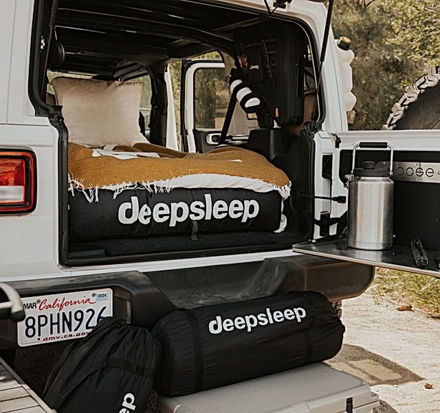 a bed in the back of a white truck