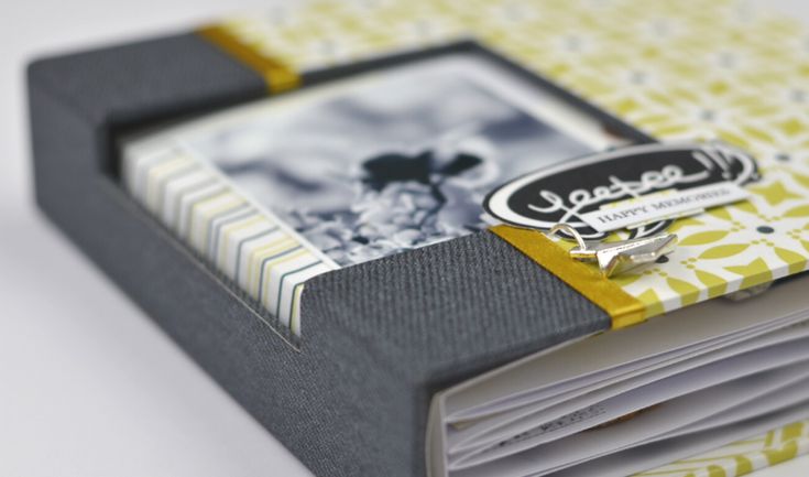 an open book with yellow and white designs