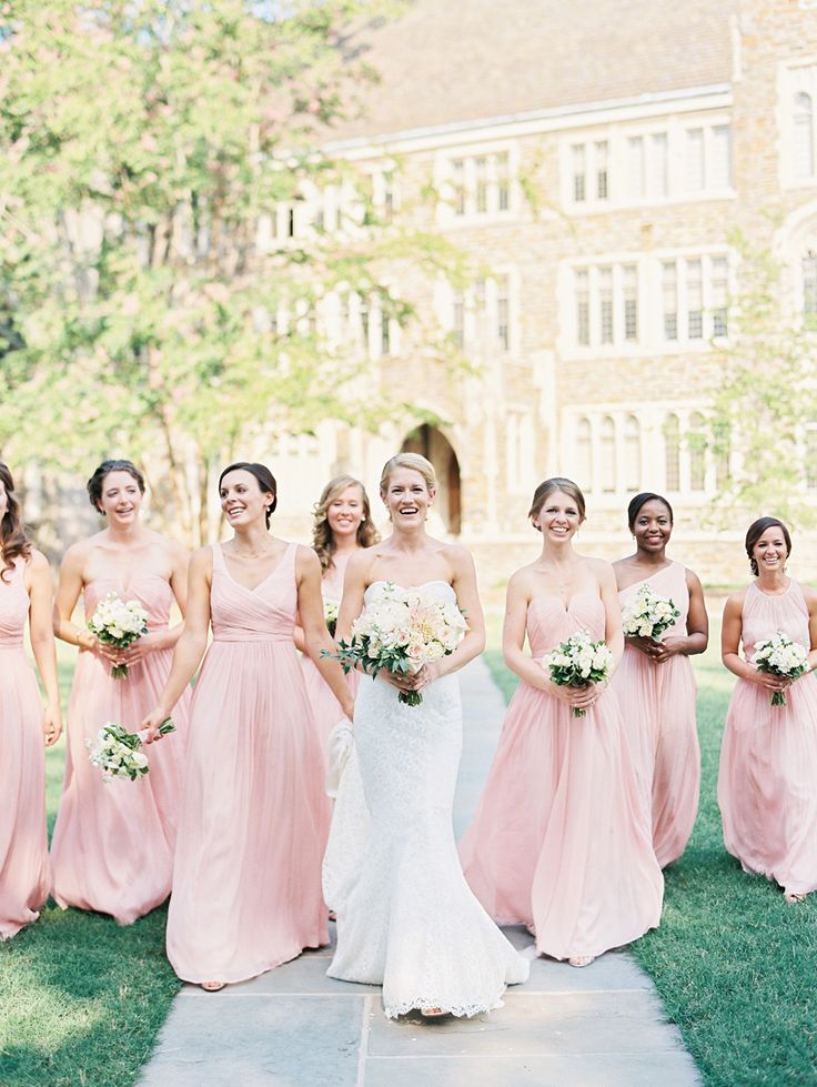 a bride and her bridal party in pink dresses