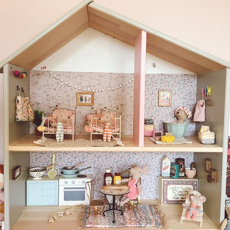 a doll house with furniture and accessories on the shelves in front of it is shown