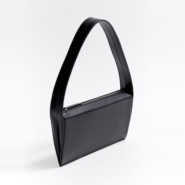 Meet The Edge, our sleek shoulder bag made in Italy with 100% traceable Catalonian leather. The sleek tulip-shaped gussets support a suede-lined interior that easily fits your phone, cardholder, lipstick, keys, and hand sanitizer. A bold shoulder strap provides maximum comfort and style. Sleek Shoulder Bag For Daily Use, Everyday Structured Shoulder Bag With Smooth Grain, Sleek Baguette Shoulder Bag For Everyday Use, Structured Shoulder Bag With Smooth Grain For Daily Use, Modern Business Satchel Baguette Bag, Modern Baguette Shoulder Bag For Business, Modern Business Baguette Satchel Bag, Modern Baguette Bag With Double Handle, Sleek Structured Shoulder Bag For Everyday